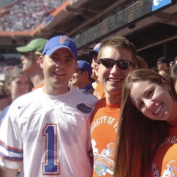 Spoores founders Sal Torre and David Tietz with Nicole Tietz in the stands at a University of Florida football game